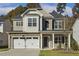 Charming two-story home with stone accents, a two-car garage, and a well-manicured lawn at 42 Chris Todd Way, Angier, NC 27501