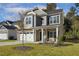 Inviting two-story home with stone details, a two-car garage, and a pleasant front yard at 42 Chris Todd Way, Angier, NC 27501