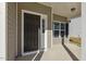 Close-up of a stylish black front door with sidelights and a covered porch at 42 Chris Todd Way, Angier, NC 27501