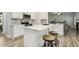 Bright kitchen featuring a center island with bar seating, stainless steel appliances, and gray backsplash at 42 Chris Todd Way, Angier, NC 27501