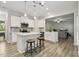 Bright kitchen featuring a center island with bar seating, stainless steel appliances, and gray backsplash at 42 Chris Todd Way, Angier, NC 27501