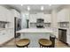 Contemporary kitchen boasting white cabinetry, stainless steel appliances, and an island with bar stools at 42 Chris Todd Way, Angier, NC 27501