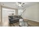 Cozy living room with wood floors, a comfortable sofa, and an open view to the kitchen at 42 Chris Todd Way, Angier, NC 27501
