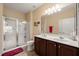 Bright bathroom offers a double vanity, a walk-in shower, and tiled floors at 463 Kerriann Ln, Clayton, NC 27520