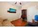 Bedroom with hardwood floors, a ceiling fan, and a large screen television at 463 Kerriann Ln, Clayton, NC 27520