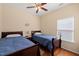 Comfortable bedroom featuring two twin beds, hardwood floors and a ceiling fan at 463 Kerriann Ln, Clayton, NC 27520