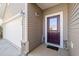 Close up of a covered entryway with decorative sconces and a glass-paneled front door at 463 Kerriann Ln, Clayton, NC 27520