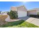 Attached garage with a white door, concrete driveway, and manicured landscaping against a sunny sky at 463 Kerriann Ln, Clayton, NC 27520