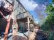 Townhome backyard featuring a covered deck, brick facade and natural landscaping at 4842 Wyatt Brook Way, Raleigh, NC 27609