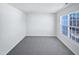 An empty, carpeted bedroom illuminated by natural light coming through the window at 4842 Wyatt Brook Way, Raleigh, NC 27609