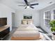 Cozy bedroom featuring a ceiling fan, natural light, and neutral decor at 4842 Wyatt Brook Way, Raleigh, NC 27609