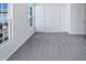 Spacious bedroom featuring two windows and three white paneled doors at 4842 Wyatt Brook Way, Raleigh, NC 27609