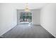 Well-lit dining room with a decorative chandelier and sliding door to backyard at 4842 Wyatt Brook Way, Raleigh, NC 27609