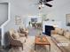 Open living room with a fireplace, ceiling fan, neutral-toned furniture and a decorative rug at 4842 Wyatt Brook Way, Raleigh, NC 27609