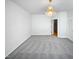 Open living room with chandelier, neutral paint, and plush carpeting at 4842 Wyatt Brook Way, Raleigh, NC 27609