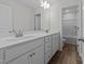 Well-lit bathroom with double sinks, stylish fixtures, and a separate shower-tub area at 5036 Trotter Dr, Raleigh, NC 27603