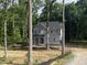 Charming new construction with vertical siding, covered porch, and picturesque wooded setting at 5036 Trotter Dr, Raleigh, NC 27603