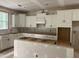 Bright new kitchen featuring white cabinets, a kitchen island, and modern design elements at 5036 Trotter Dr, Raleigh, NC 27603