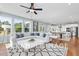 Spacious living room featuring a large sectional sofa, decorative rug, and expansive windows with neighborhood views at 5036 Trotter Dr, Raleigh, NC 27603