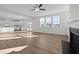 Bright, open-concept living room features hardwood floors, large windows and a modern ceiling fan at 5036 Trotter Dr, Raleigh, NC 27603