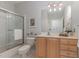 Well-lit bathroom with shower, toilet, vanity with wooden drawers, and decorative mirror at 534 Ives Ct, Chapel Hill, NC 27514