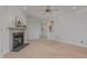 Cozy living room with neutral paint, carpet flooring, a ceiling fan, and a fireplace at 534 Ives Ct, Chapel Hill, NC 27514