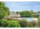 Community pool area featuring a pool house, lounge chairs, and well-maintained landscaping at 534 Ives Ct, Chapel Hill, NC 27514