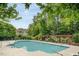 Community pool with pergola covered seating area and mature trees for a tranquil outdoor experience at 534 Ives Ct, Chapel Hill, NC 27514