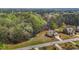 Aerial view of the property showcases the home's setting, trees, landscaping, and neighborhood at 5421 Downton Grove Ct, Fuquay Varina, NC 27526