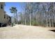 Large backyard with a patio, shed, and wooded area, perfect for outdoor activities and relaxation at 5421 Downton Grove Ct, Fuquay Varina, NC 27526