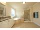 Bathroom featuring double vanity, a soaking tub, and a glass enclosed shower at 5421 Downton Grove Ct, Fuquay Varina, NC 27526