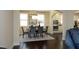Elegant dining room featuring a chandelier, gray upholstered chairs, and view of the kitchen at 5421 Downton Grove Ct, Fuquay Varina, NC 27526