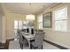 Bright dining room with chandelier, large windows, and view of screened porch at 5421 Downton Grove Ct, Fuquay Varina, NC 27526
