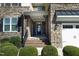 Inviting front entrance with stone facade, brick steps, and a welcoming 'Welcome' sign at 5421 Downton Grove Ct, Fuquay Varina, NC 27526