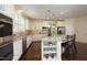 Modern kitchen with white cabinets, granite countertops, stainless steel appliances, and a large kitchen island at 5421 Downton Grove Ct, Fuquay Varina, NC 27526