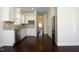 Bright, modern kitchen showcasing stainless steel appliances, white cabinets, and dark wood floors at 5421 Downton Grove Ct, Fuquay Varina, NC 27526