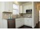 Modern kitchen features stainless steel appliances, white cabinets and granite countertops at 5421 Downton Grove Ct, Fuquay Varina, NC 27526