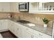 Bright kitchen features granite countertops, stainless steel appliances, and off-white cabinetry at 5421 Downton Grove Ct, Fuquay Varina, NC 27526