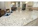 Kitchen island with granite countertop, seating for three, and pendant lighting at 5421 Downton Grove Ct, Fuquay Varina, NC 27526