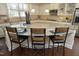 Spacious kitchen with an expansive island, granite countertops, and seating for three at 5421 Downton Grove Ct, Fuquay Varina, NC 27526