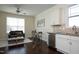 Open concept living room with ceiling fan, dining table, couch, and full kitchen at 5421 Downton Grove Ct, Fuquay Varina, NC 27526