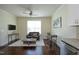 Bright living room featuring dining table, ceiling fan, couch and stainless steel dishwasher at 5421 Downton Grove Ct, Fuquay Varina, NC 27526
