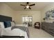 Spacious primary bedroom featuring a ceiling fan, sliding glass door, and a dresser at 5421 Downton Grove Ct, Fuquay Varina, NC 27526