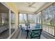 Inviting screened porch with ceiling fan, dining set, and views of the surrounding trees and landscaping at 5421 Downton Grove Ct, Fuquay Varina, NC 27526