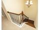 View of the staircase with beautiful hardwood steps, elegant iron spindles, and a stylish chandelier at 5421 Downton Grove Ct, Fuquay Varina, NC 27526