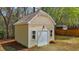 Close-up view of the storage shed featuring windows, double doors, and durable exterior at 5421 Downton Grove Ct, Fuquay Varina, NC 27526