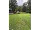 Backyard with a picnic table, deck, and black metal fence at 55 Waters Edge Loop, Henderson, NC 27537