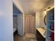 Bathroom featuring a vanity with sink, a round mirror, and a shower with curtain at 55 Waters Edge Loop, Henderson, NC 27537
