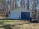 Two-car garage in a large, wooded backyard with two doors at 55 Waters Edge Loop, Henderson, NC 27537