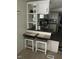 Eat-in kitchen bar with seating for two, with open access to the adjacent kitchen and dining area at 55 Waters Edge Loop, Henderson, NC 27537